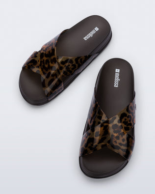 Top view of a pair of dark brown/tortoise Cozy Cross sandals with crisscross top straps