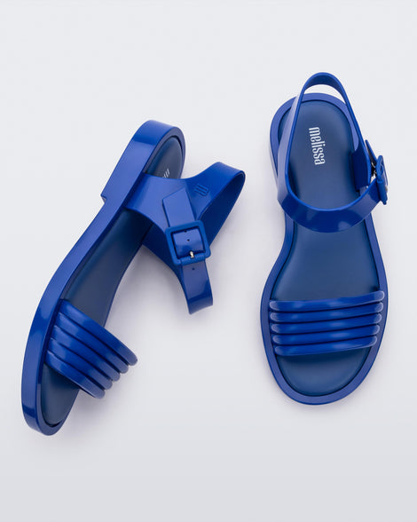 Top and side view of a pair of blue Mar Wave women's sandals.