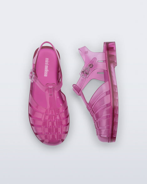 Top and side view of a pair of transparent pink Possession fisherman kids sandals