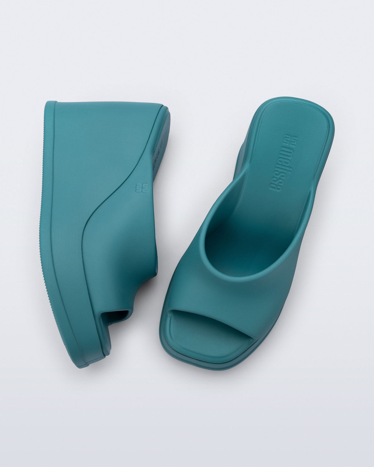 Top and side view of a pair of blue/green Free Slip platform wedge heels