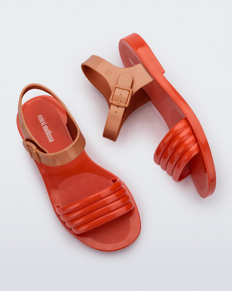 Side and top view of a pair of red Mar Wave kids sandals with brown strap.