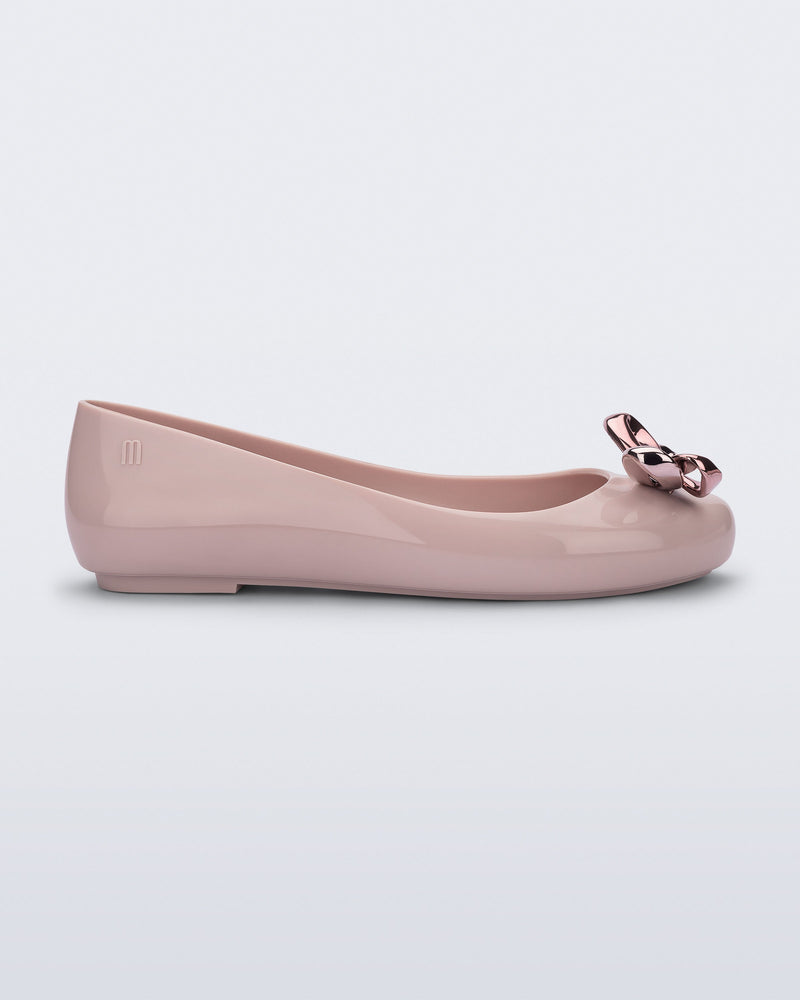 Side view of a pink Sweet Love Glam ballerina flat with pink chrome bow