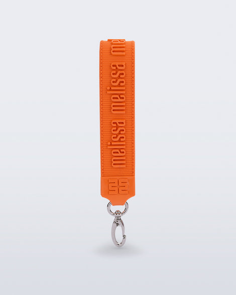 Front view of an orange M Lover Charm with the Melissa logo