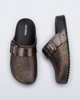 Side and top view of a pair of mixed glitter/black Cozy Clog for kids
