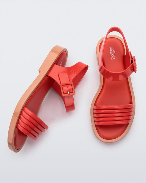 Top and side view of a pair of red Mar Wave women's sandals with beige sole