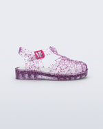 Side view of a clear Possession Elements baby sandal with pink glitter hearts