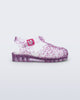 Side view of a clear Possession Elements baby sandal with pink glitter hearts