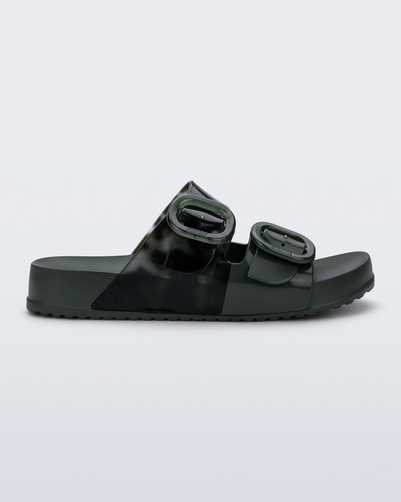 Side view of a dark green Cozy slide with part clear green upper with 2 buckles