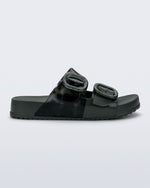 Side view of a dark green Cozy slide with part clear green upper with 2 buckles