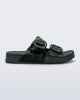 Side view of a dark green Cozy slide with part clear green upper with 2 buckles