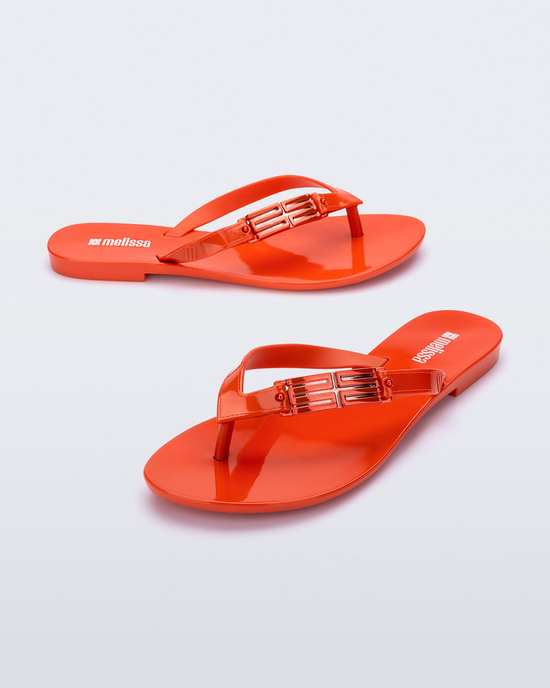 Side and angled view of a pair of red Harmonic M Chic