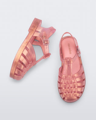 Top and side view of a pair of pearly pink kids Possession sandals