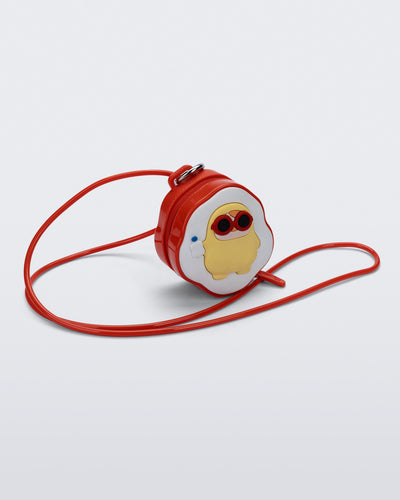 Angled view of a red Bag + Pop Mart Pucky small bag with short strap