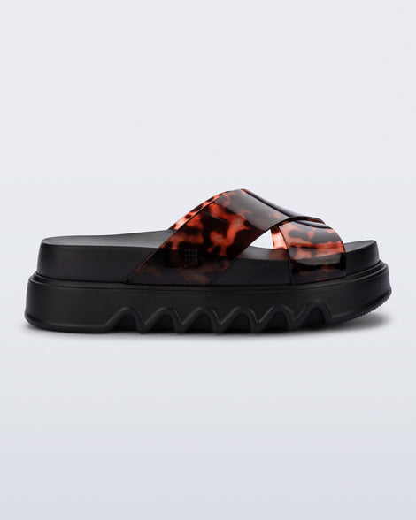 Side view of a black/tortoise Cozy Cross platform sandal with crisscross top straps