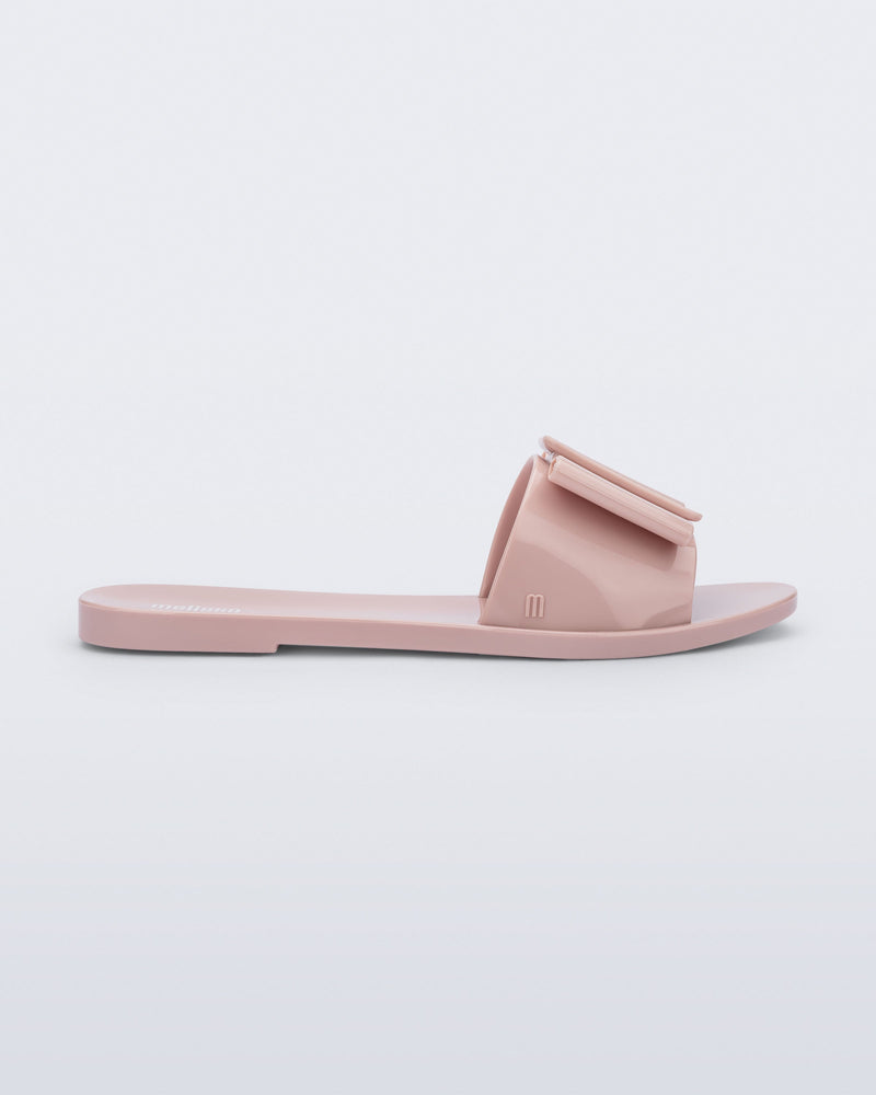 Side view of a light pink Babe slide sandal