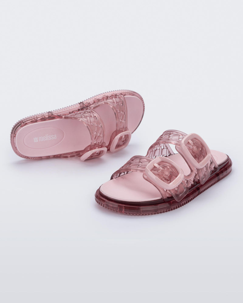 Top and angled view of a transparent pink Possession Slip sandals with two top straps