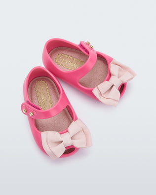 Top view of a pair of pink My First Melissa mary jane with a pink bow.