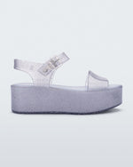 Side view of a glitter lilac Melissa platform sandal with a front and ankle strap