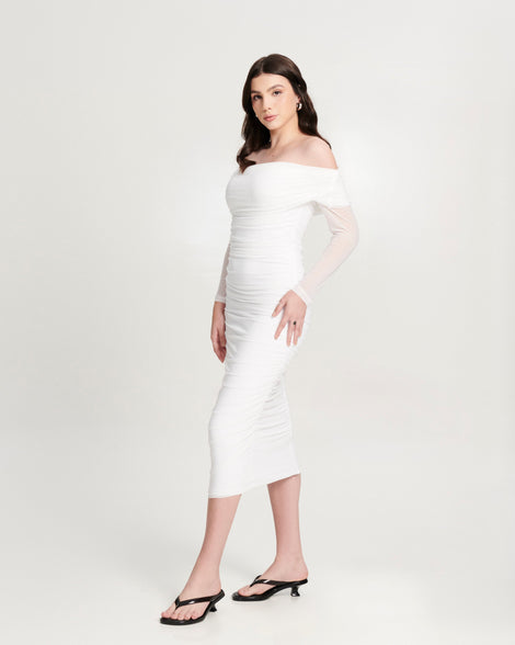Model in a white dress wearing a pair of black Flip Flop Kitten Heels