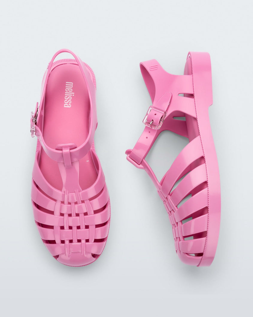 A top and side view of a pair of pink Melissa Possession sandals with a fisherman sandal design