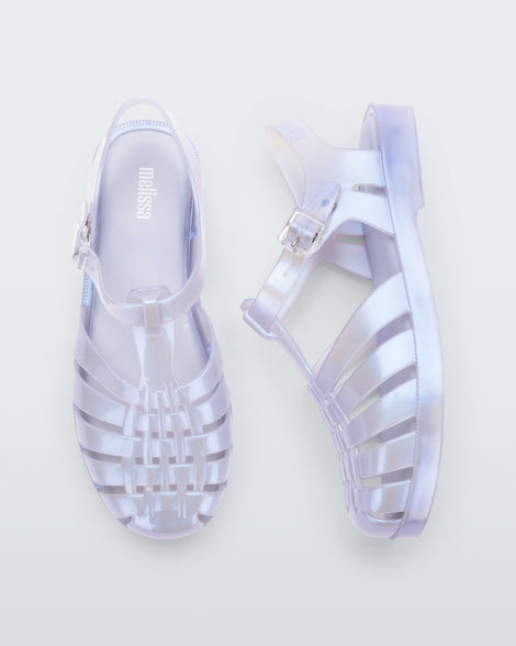 A top and side view of a pair of pearly blue Melissa Possession sandals with a fisherman sandal design