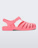 Side view of a coral pink Melissa Possesion sandal.