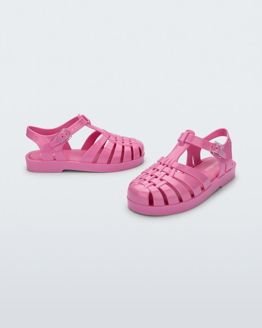 An angled front and side view of a pink blue Mini Melissa Possession sandals with a fisherman sandal design