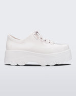 Side view of Melissa Kick Off platform sneaker in white. The sneaker has traditional white tie up laces.