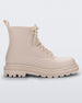 Side view of a beige Melissa Coturno boot.