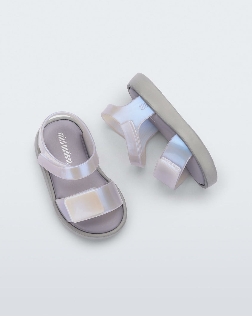 Top and Side view of a pair of pearly blue Mini Melissa Jump baby sandal.