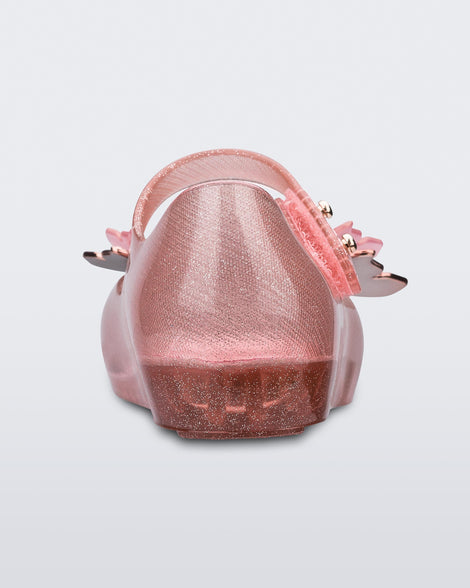 Back view of a glitter clear pink Mini Melissa Ultragirl Butterfly baby mary jane flat with two metallic and clear butterflies and peep toe.