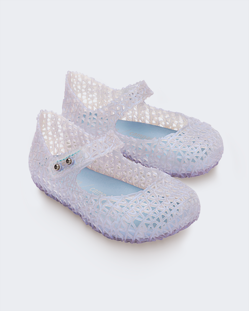 An angled side view of a pair of pearly blue Mini Melissa Campana flats with a distinctive interwoven pattern