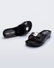 Top and angled view of a pair of black Pescura Heel + Scholl slides with top buckle