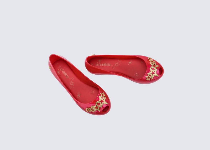 Top view of a pair of red Ultragirl Stars kids ballerina flat with stars on the upper
