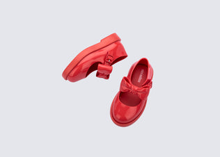 Top and side view of a pair of red Blair baby mary  janes with bow in the strap