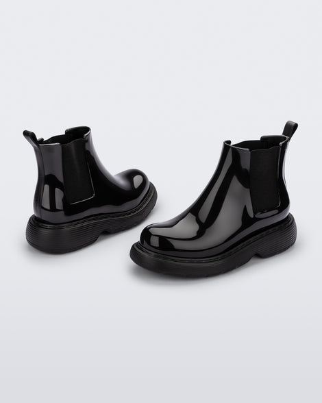 Angled view of a pair of a black Melissa Step boots.