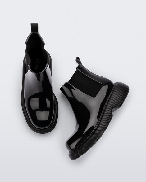 Side and top view of a pair of black Melissa Step boots.