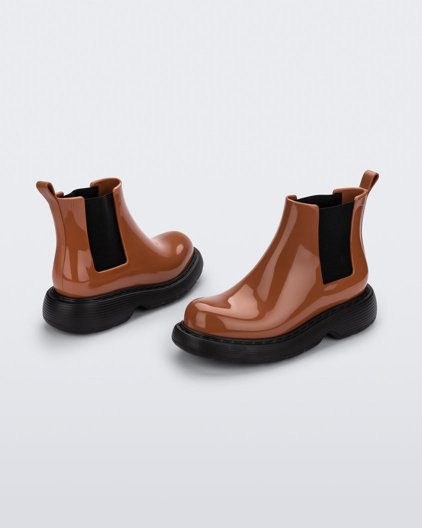 Angled view of a pair of a brown/black Melissa Step boots.