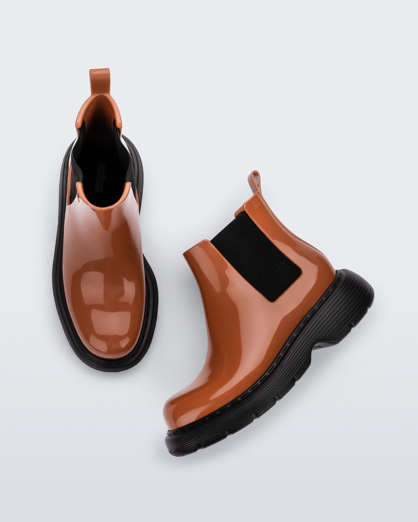 Side and top view of a pair of brown/black Melissa Step boots.