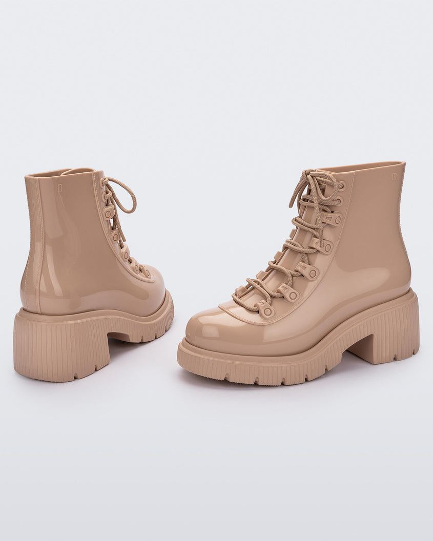 Side and back view of a pair of a beige Melissa Cosmo boots.