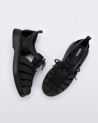 Side and top view of a pair of black Match sneaker sandals