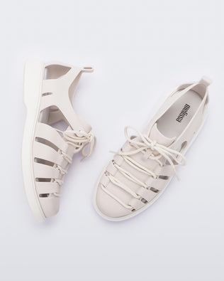 Side and top view of a pair of white Match sneaker sandals