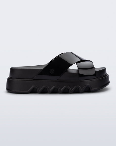 Side view of a black Cozy Cross platform sandal with crisscross top straps