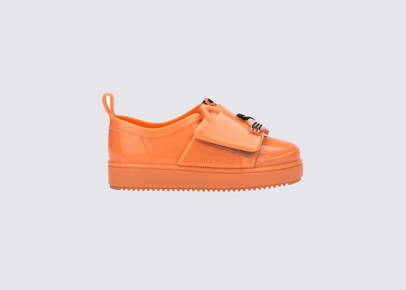 Side view of an orange Jelly Pop Safari baby sneaker