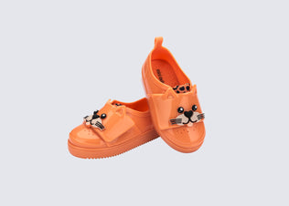 Angled view of a pair of orange Jelly Pop Safari baby sneakers