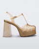 Side view of a beige glitter gold Melissa Party platform heel. 