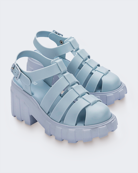Angled view of a pair of Melissa Megan platform sandals in light blue