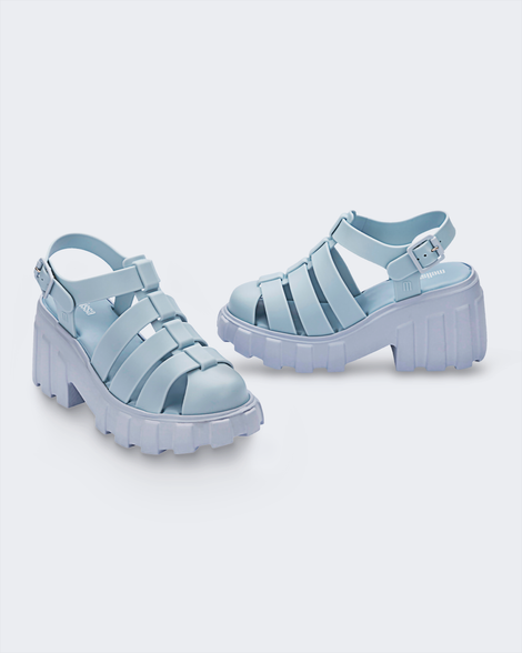 Angled view of a pair of Melissa Megan platform sandals in light blue
