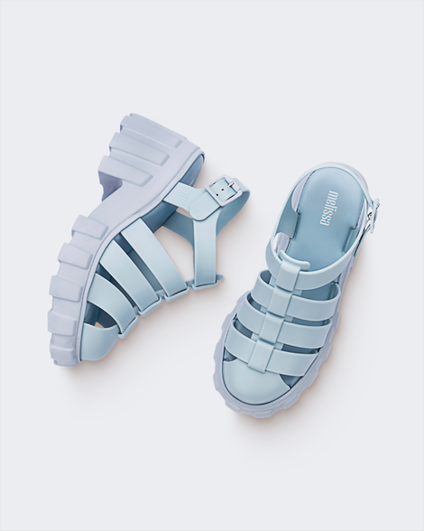 Top and side view of a pair of Melissa Megan platform sandals in light blue
