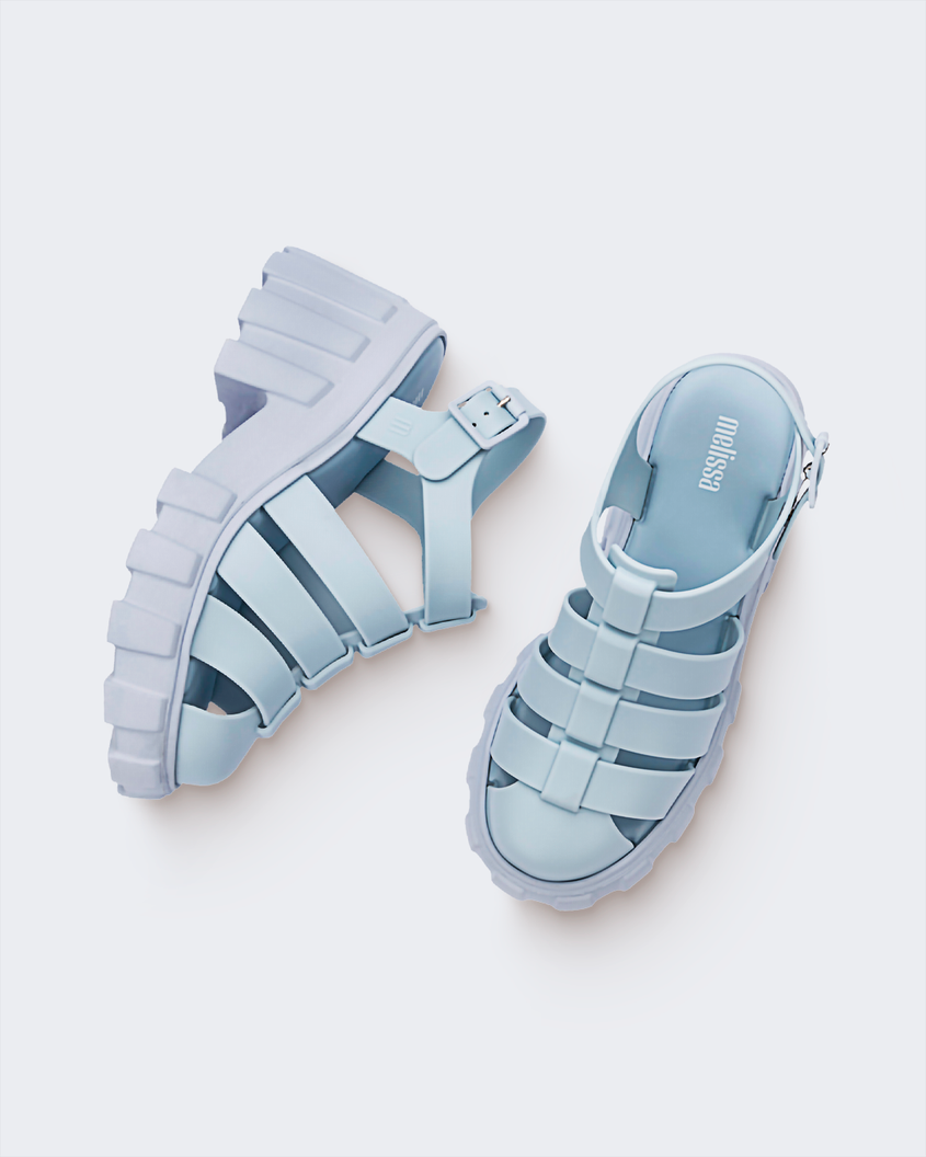 A top and side view of a pair of light blue Melissa Megan platform sandal heels with a fisherman sandal design